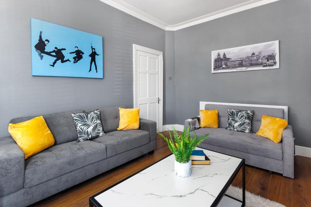 a living room with two couches and a coffee table at Crawford Avenue Retreat in Liverpool