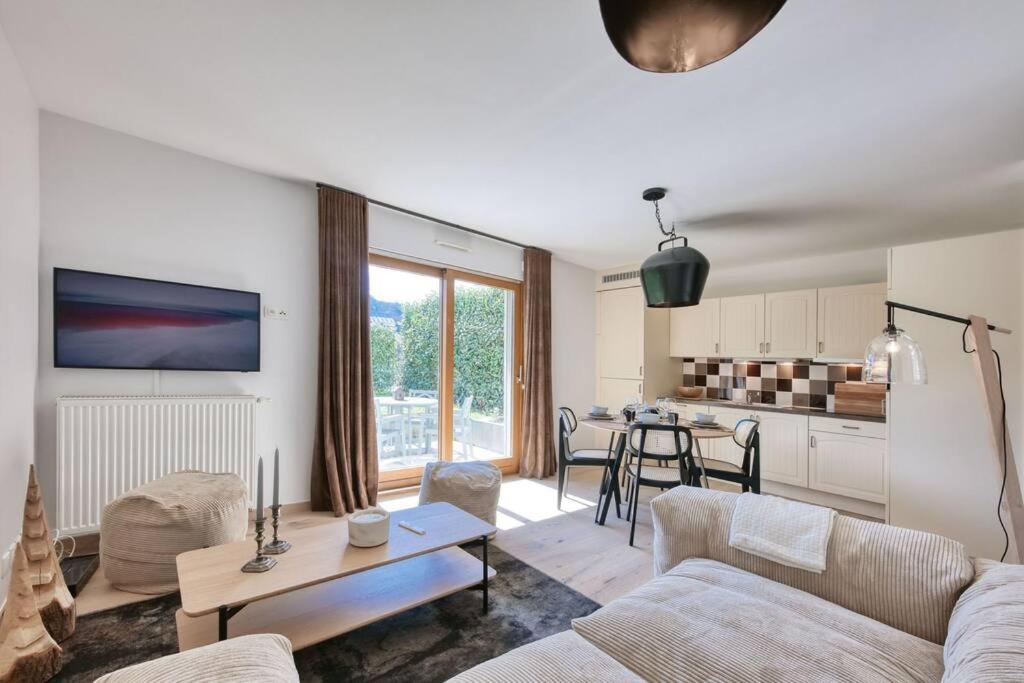 a living room with a couch and a table at La Collection - Le Village in Saint-Gervais-les-Bains