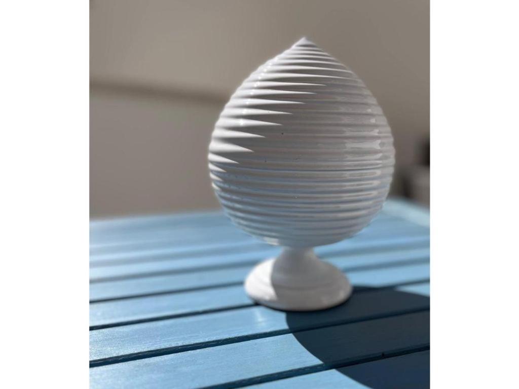 a white vase sitting on top of a table at Dimora Idrusa in Otranto