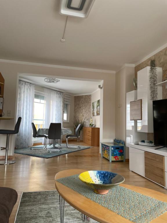 a living room with a table and a kitchen at Apartment Katharina in Klagenfurt