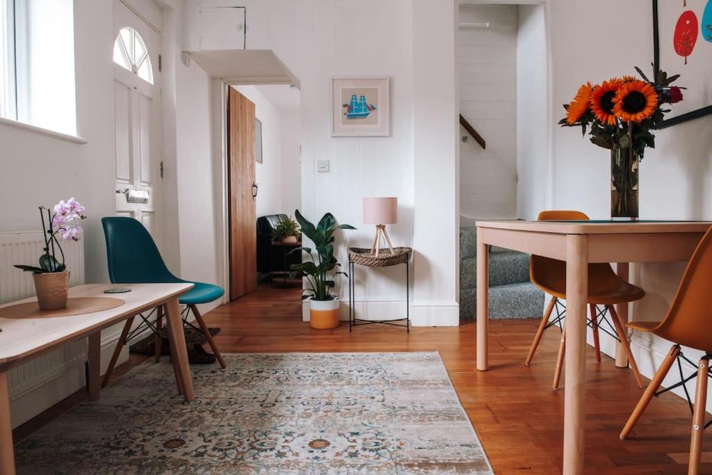 a living room with a table and chairs at Albion Cottage central Falmouth with parking and 10 minutes to the beach in Falmouth