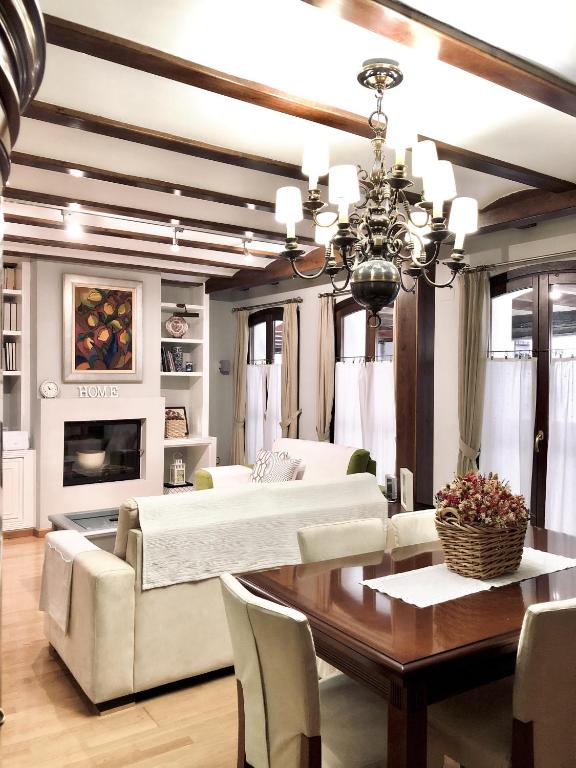 a living room with a couch and a dining room table at La Porticada Boutique House in Morella