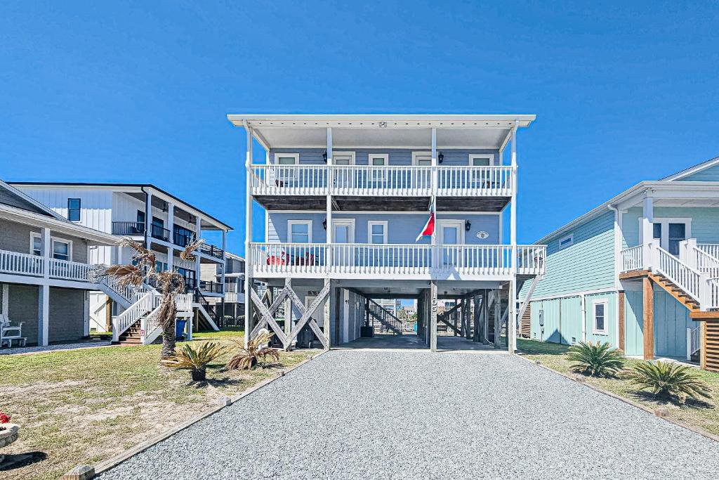 a large blue house with a white balcony at HB261 Rosie's Rendezvous in Holden Beach