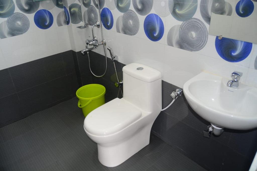 烏蒂的住宿－Vanam Holidays Inn，浴室配有白色卫生间和盥洗盆。