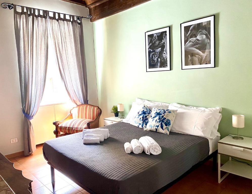 a bedroom with a bed with two towels on it at Laterano Apartment in Rome