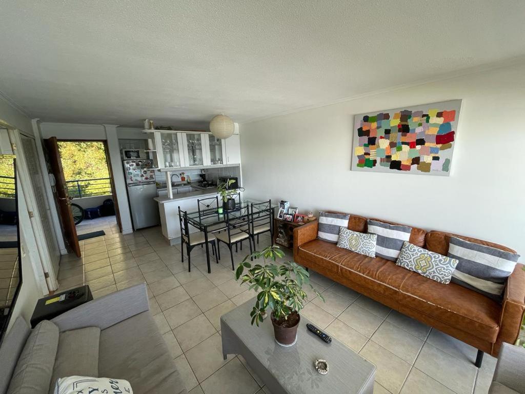 a living room with a couch and a table at VADIGI COCHOA in Viña del Mar