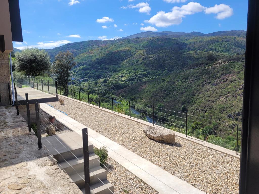 a balcony with a view of a mountain at INFINITY HOUSES in Ponte da Barca
