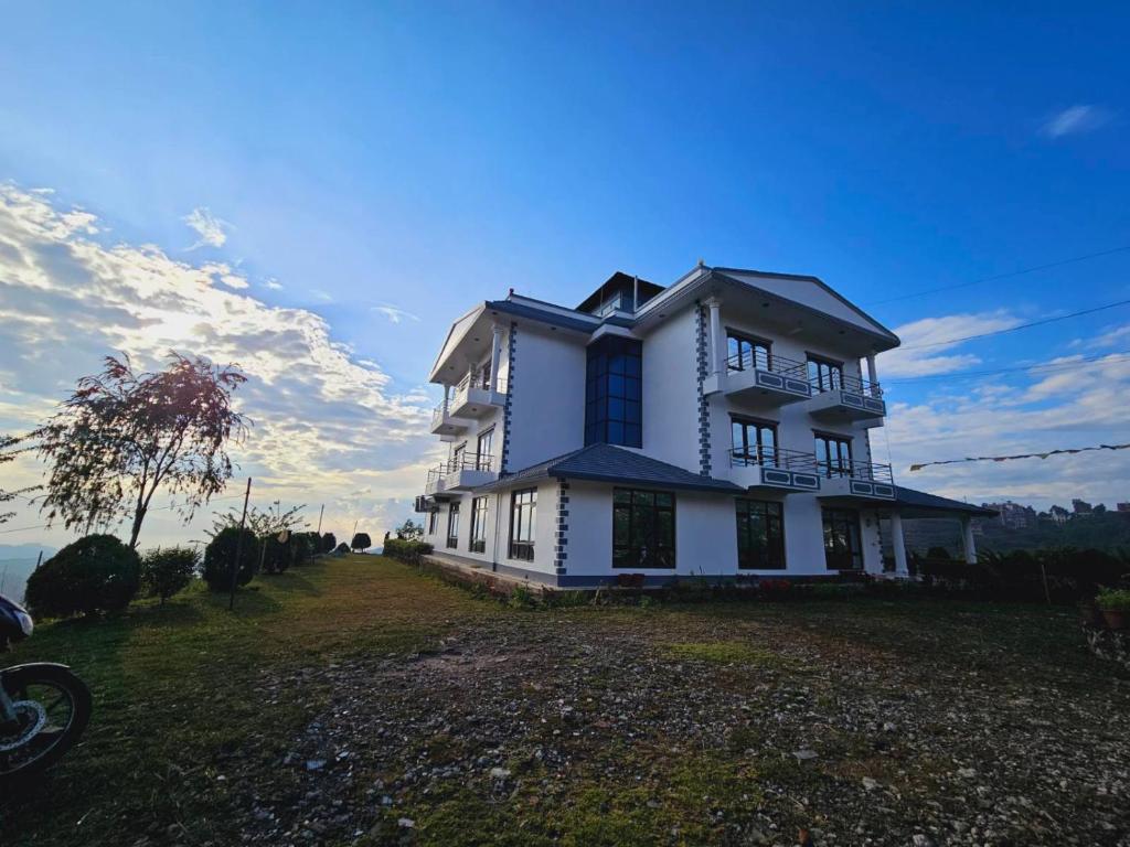 a white house on top of a hill at Hotell Hill Crown in Nagarkot