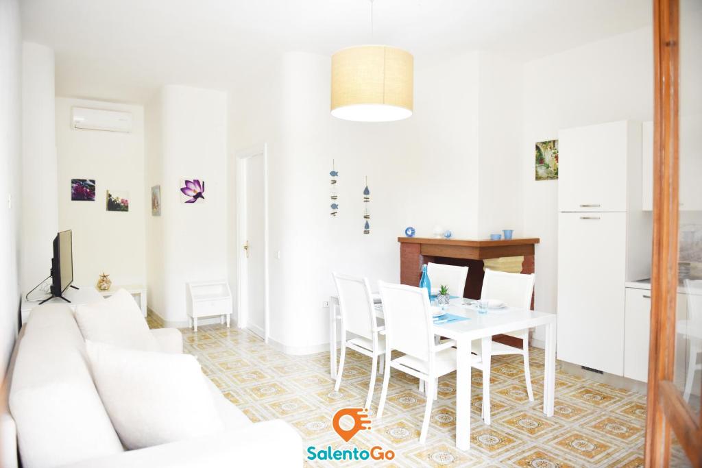 - un salon avec un canapé blanc et une table dans l'établissement BAHIA SOLE by SalentoGo, à Torre Lapillo
