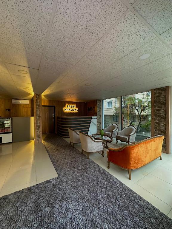 a lobby with couches and chairs in a building at Erbay Mansions Hotel in Trabzon