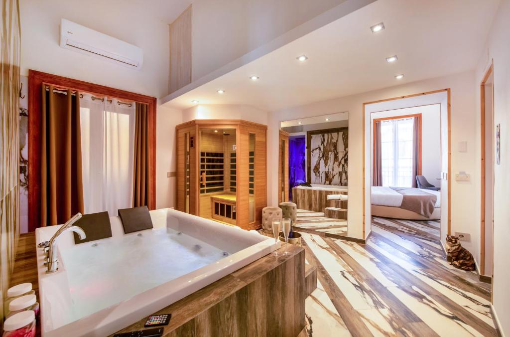 une grande salle de bains avec baignoire et une chambre dans l'établissement Sant'Antonino Luxury Suite, à Sorrente