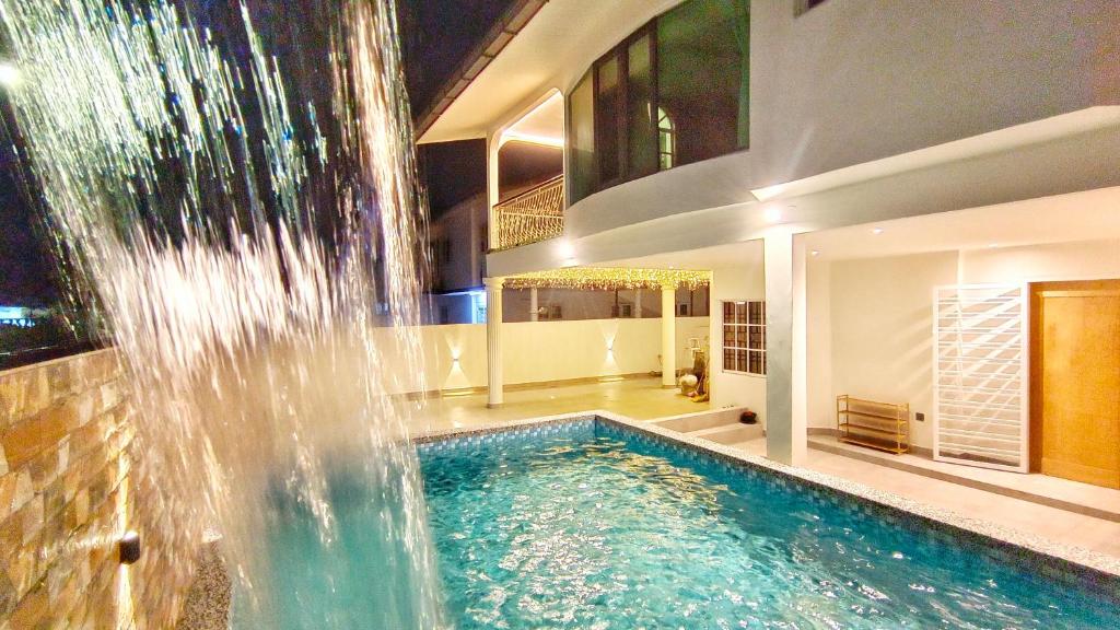 a swimming pool with a waterfall in a house at JB City Villa (Private Pool) in Johor Bahru