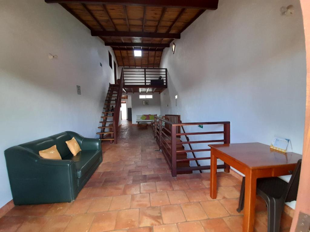 sala de estar con sofá verde y mesa de madera en La Morada Hospedaje en Barichara