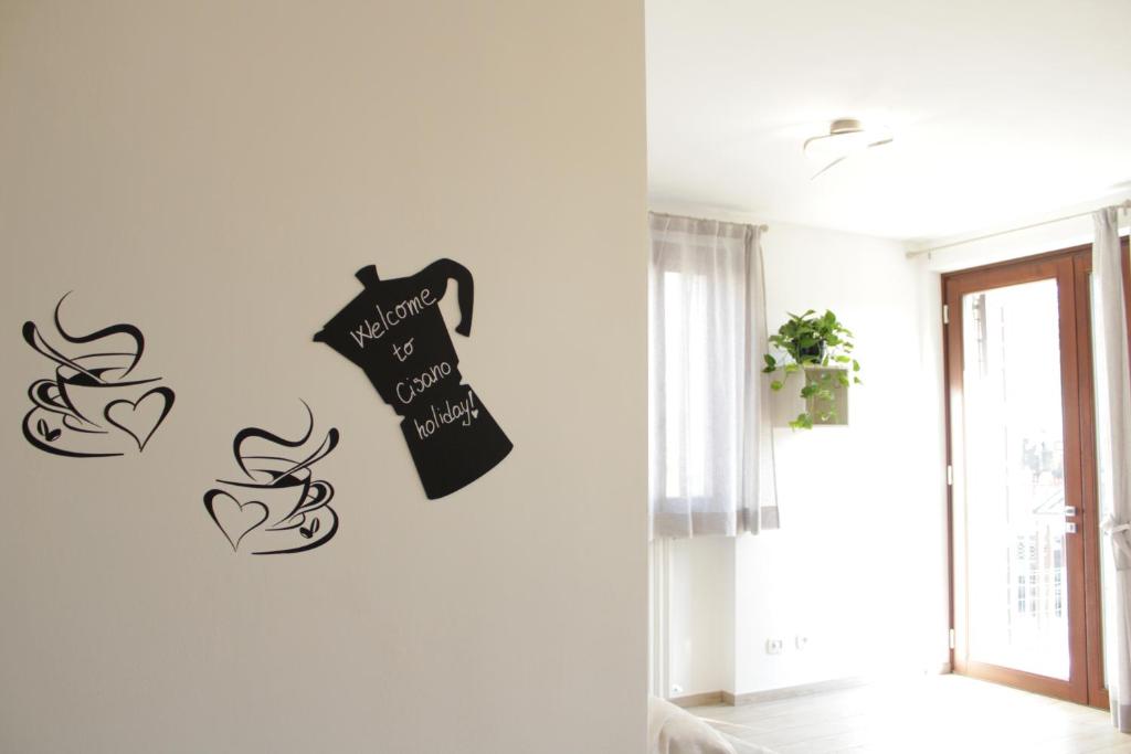 a white wall with a black shirt hanging on a wall at Cisano Holiday Apartment in Bardolino