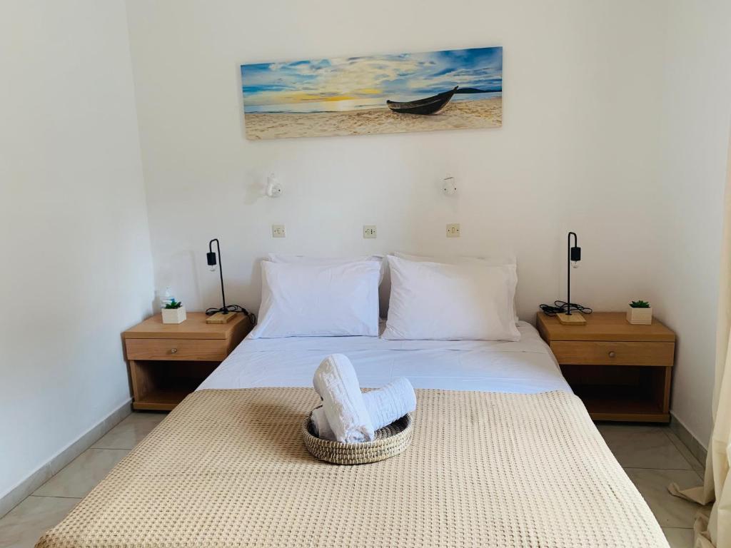 a bedroom with a bed with a basket on it at Skopelos Inn in Stafylos