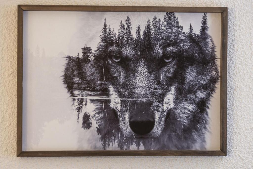 a painting of a wolf on a wall at Studio cabine Le Charvet in Le Grand-Bornand