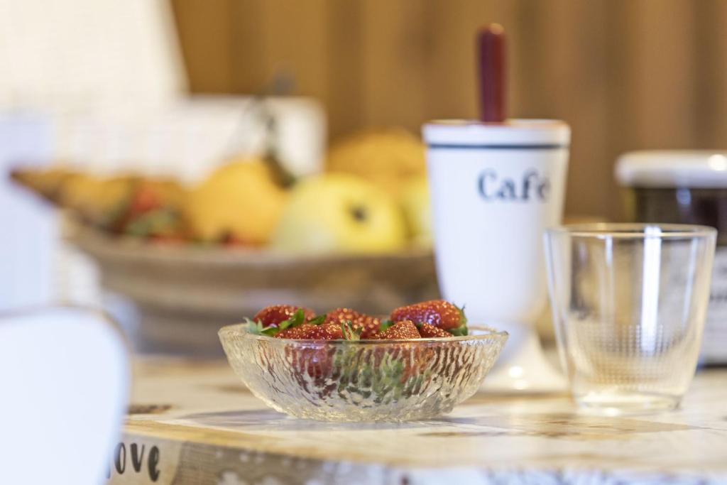a bowl of strawberries on a counter with a bowl of fruit at Studio cabine Le Charvet in Le Grand-Bornand