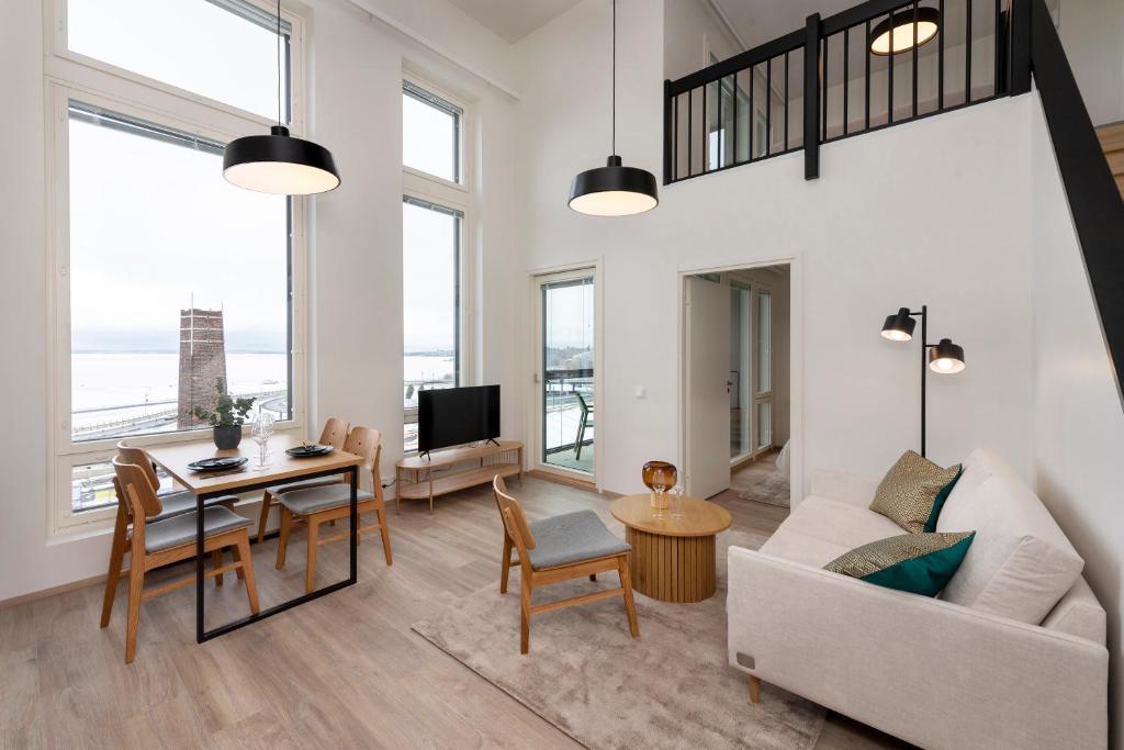 a living room with a couch and a table at Näsijärvi lakeview apartment in Tampere