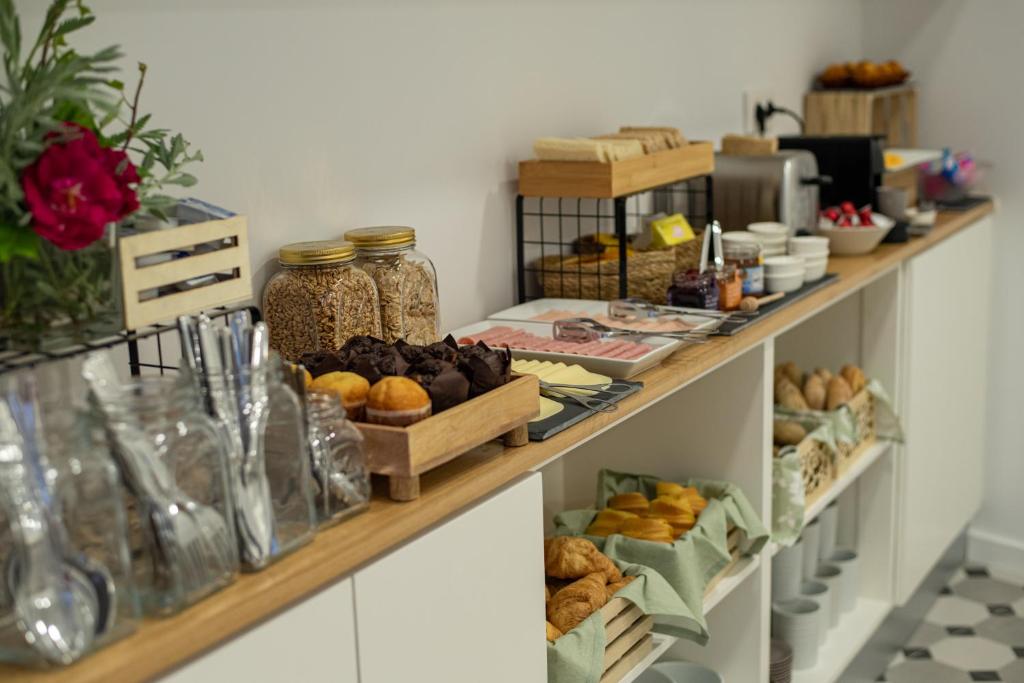 a shelf filled with lots of different types of food at Olive Boutique Guesthouse in Vila Franca do Campo
