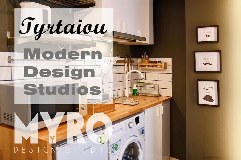 a kitchen with a washing machine in a room at #Tyrtaiou Modern Design Studio in Mytilini