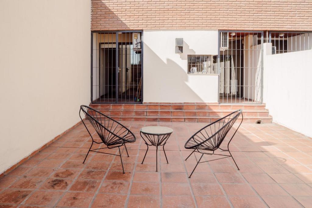 Duas cadeiras e uma mesa num pátio em Departamento en Obispo Trejo by Lofty em Córdoba