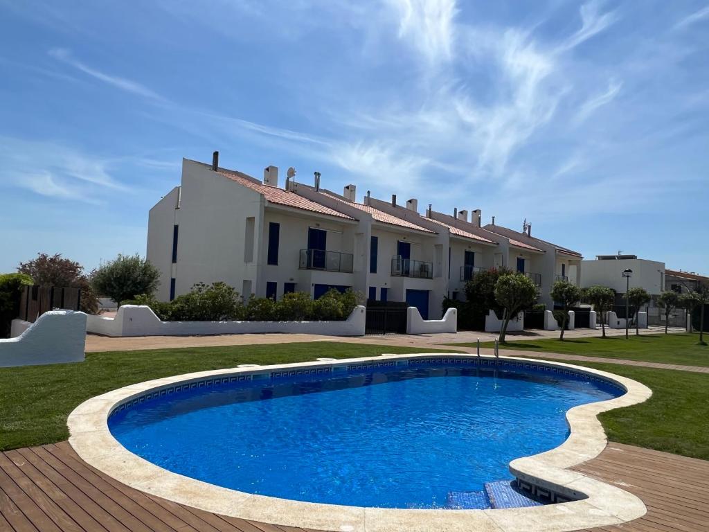 a villa with a swimming pool in front of a house at Les Dunes 5081 in Torroella de Montgrí