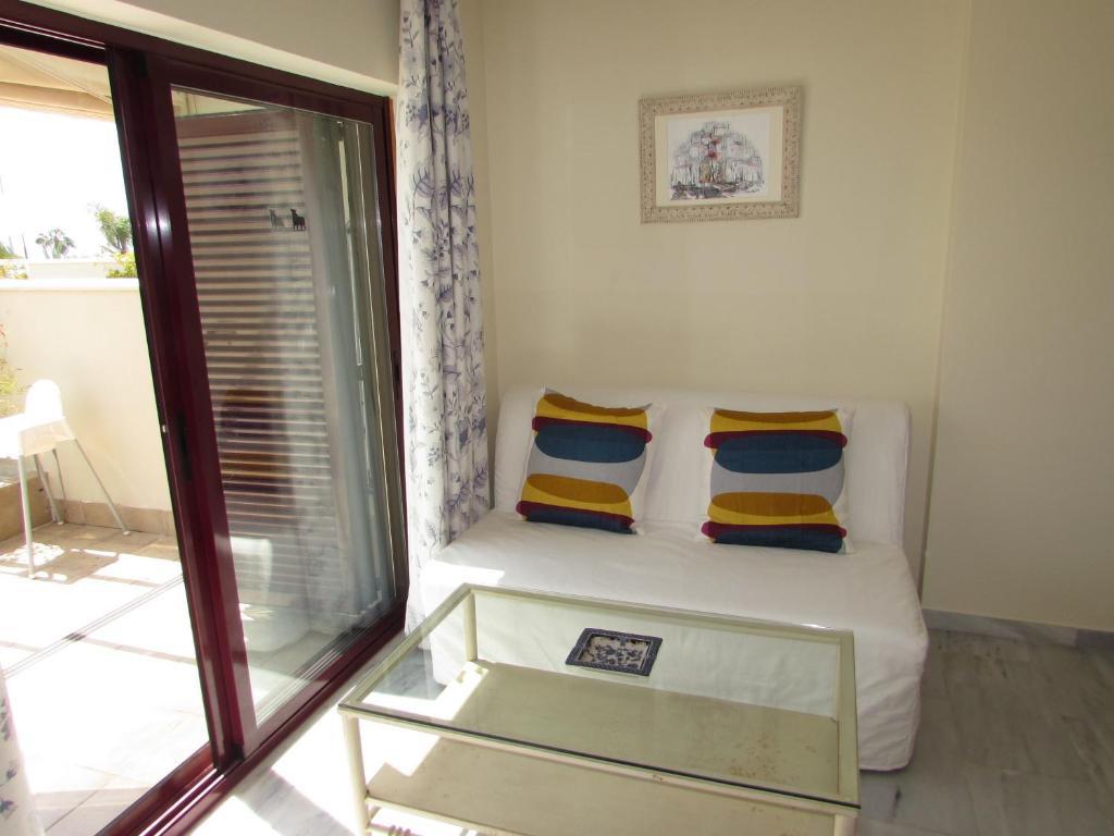a small room with a bed with two pillows at Home4Holidays in Nerja