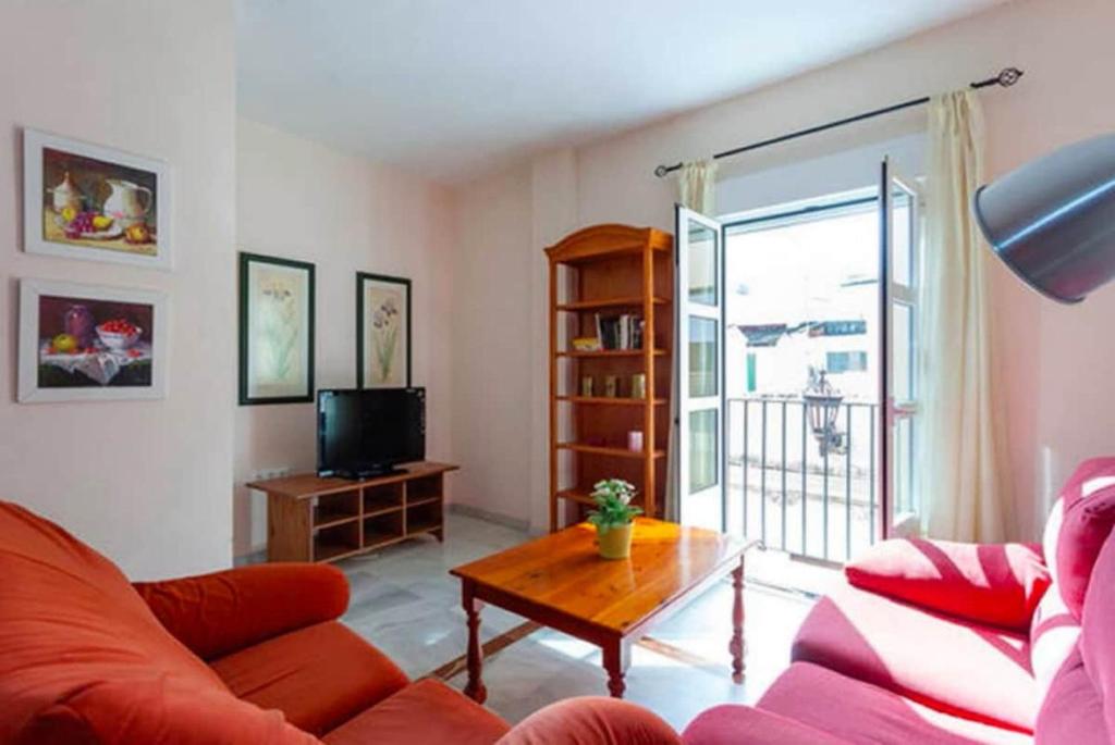 a living room with a couch and a table at Lightbooking Mazarredo San Fernando in San Fernando