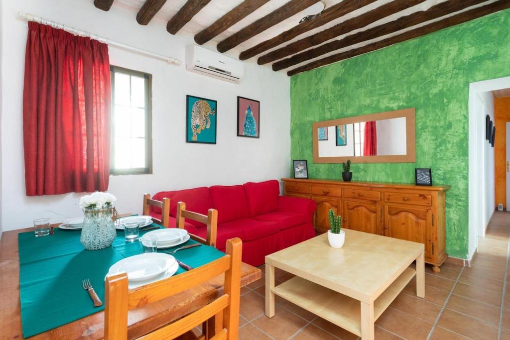 a living room with a red couch and a table at Lightbooking La Hoya Tenerife in Güimar