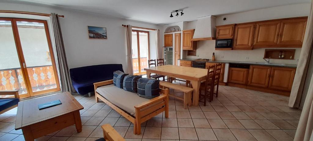 a kitchen and dining room with a table and chairs at La Turra in Lanslebourg-Mont-Cenis