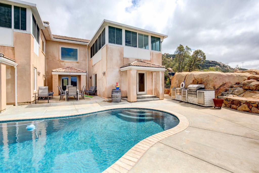a large swimming pool in front of a house at Mountaintop Ramona Home Private Pool, Near Lake! in Ramona
