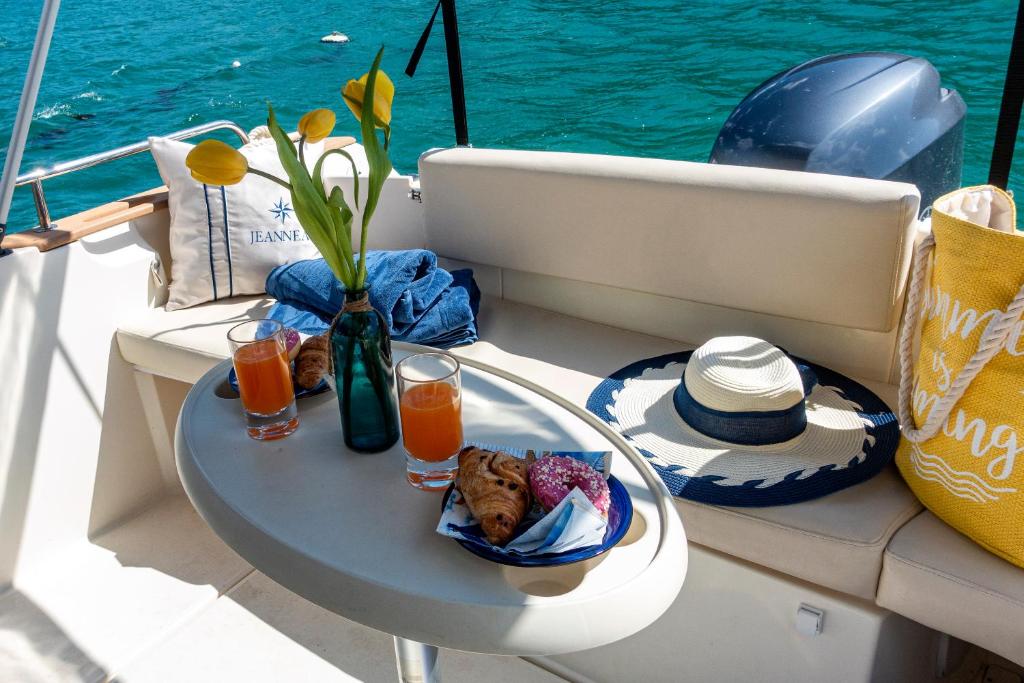a table with a plate of food on a boat at Private boat with skiper in Prijevor