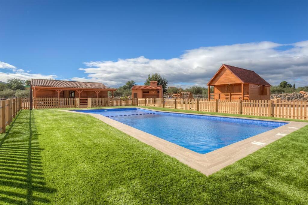 a swimming pool in a yard with a wooden fence at Villa Vilosa - Anna in Anna