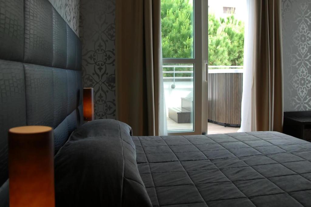 Postel nebo postele na pokoji v ubytování Atmosfere Milano Marittima
