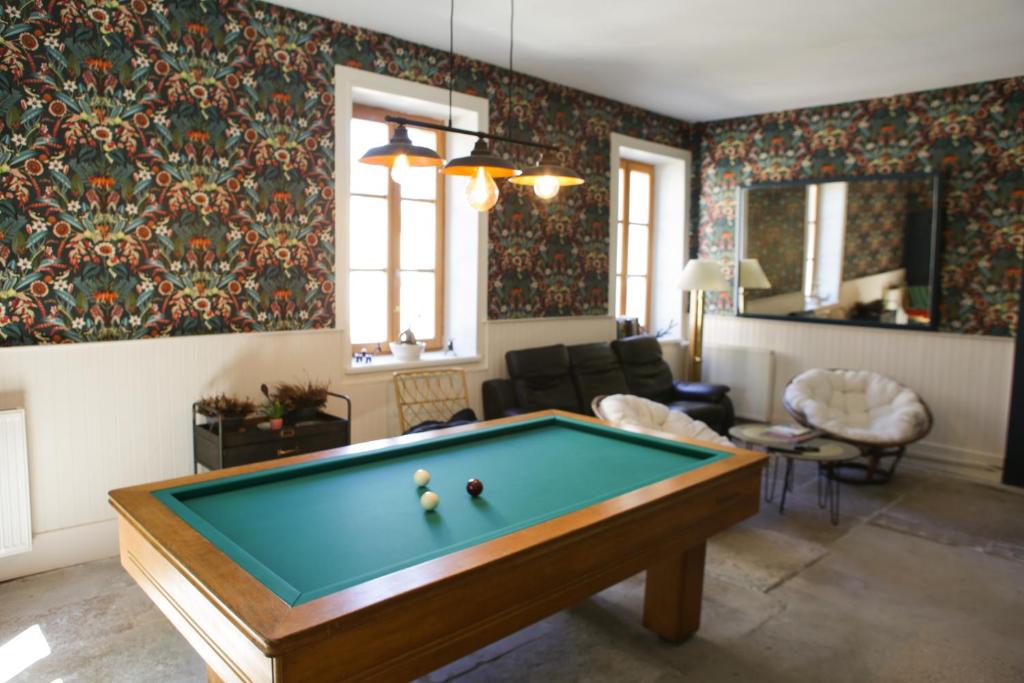 a living room with a pool table in it at Arc en Sel Maison d’hôtes in Arc-et-Senans