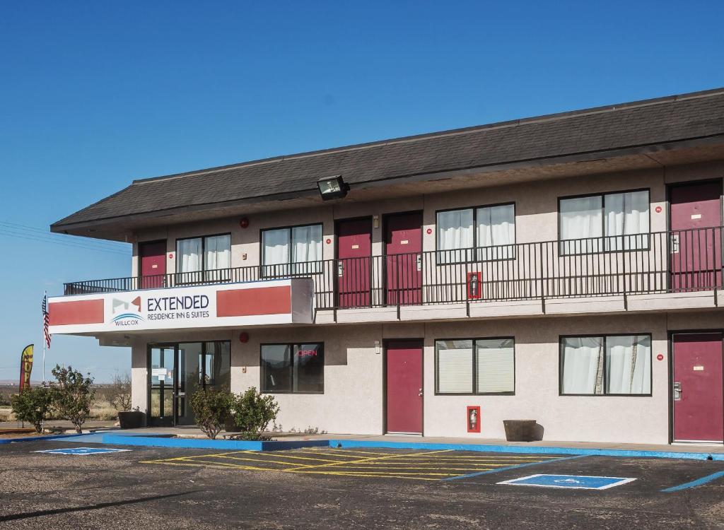 a building with red doors and a balcony at Willcox Extended Residence Inn and Suites in Willcox