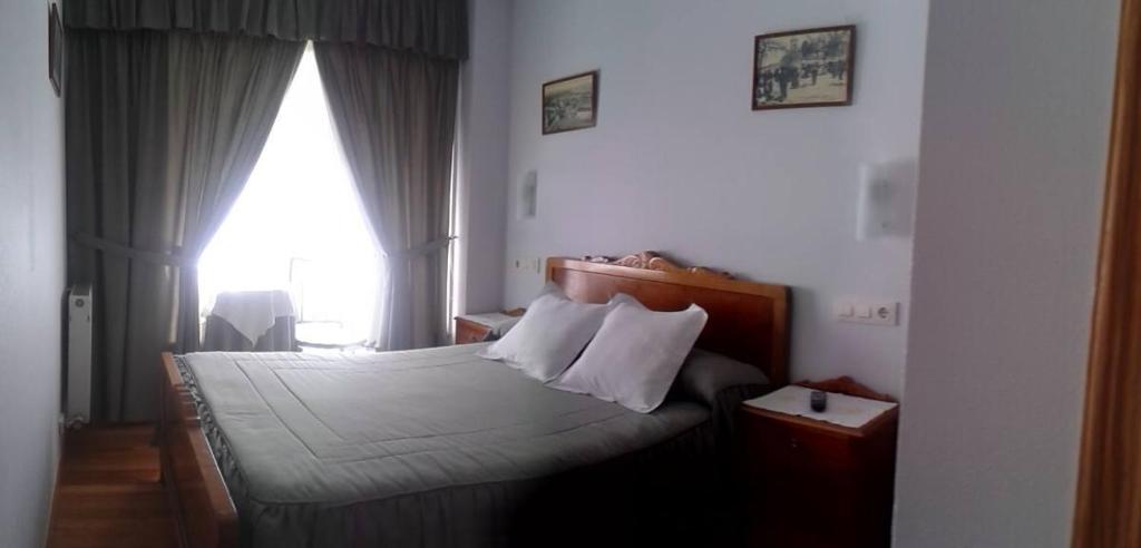 A bed or beds in a room at Hostal Pumar