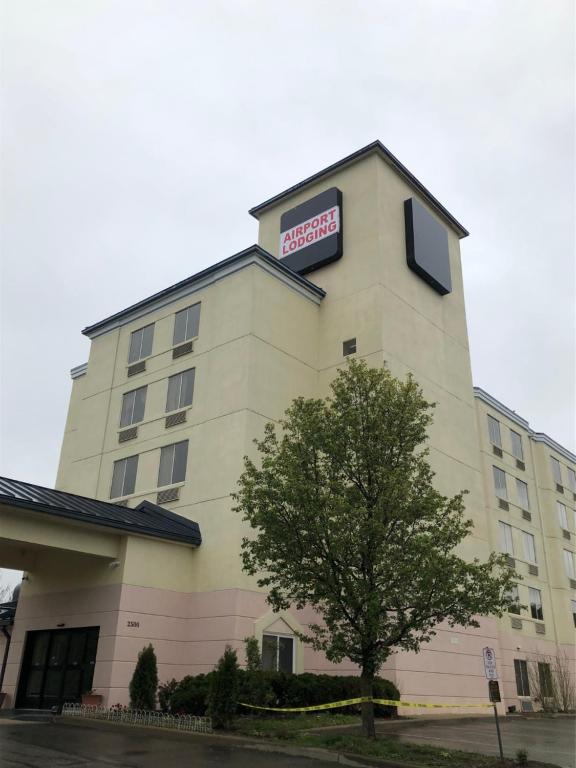 a hotel building with a sign on top of it at AIRPORT LODGING Pittsburgh Airport in Coraopolis