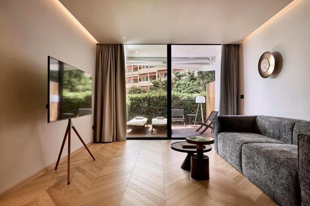a living room with a couch and a table at Cama Luxury Suites Kavouri in Athens