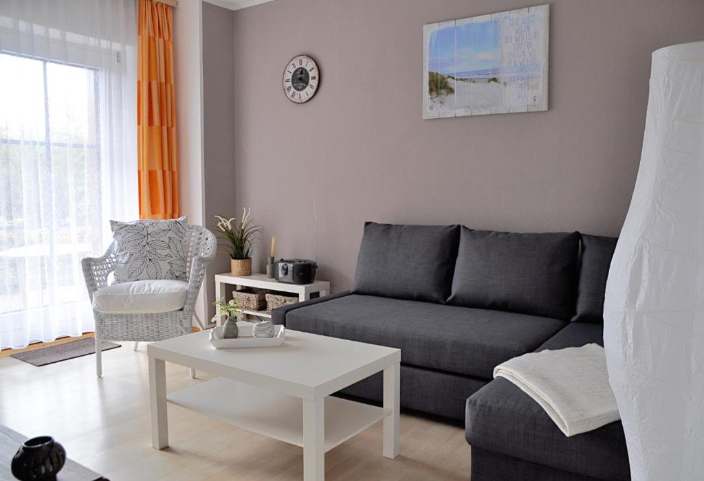 a living room with a couch and a table at Ort Lemkenhafen Bolle in Fehmarn