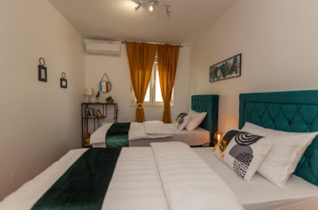 Postel nebo postele na pokoji v ubytování Matic Apartments