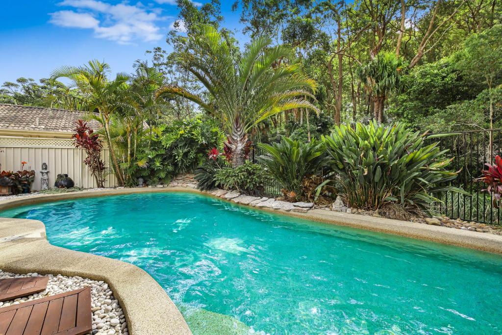 a swimming pool in a yard with trees at Heated Pool, Beach Side Entetainer, Sleeps 18 in Umina