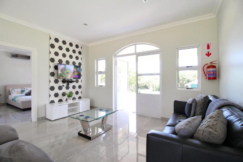 a living room with a couch and a glass table at Caribbean 1136 by Top Destinations Rentals in Port Edward