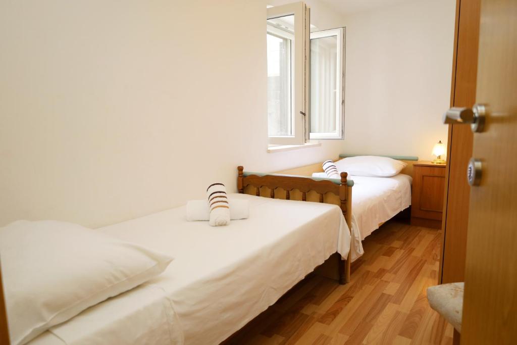a bedroom with two beds and a window at Apartment Pojatica Sumartin in Sumartin