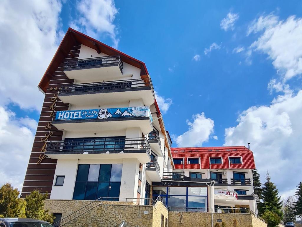 a hotel building with a sign on it at Hotel Ski&Sky in Predeal