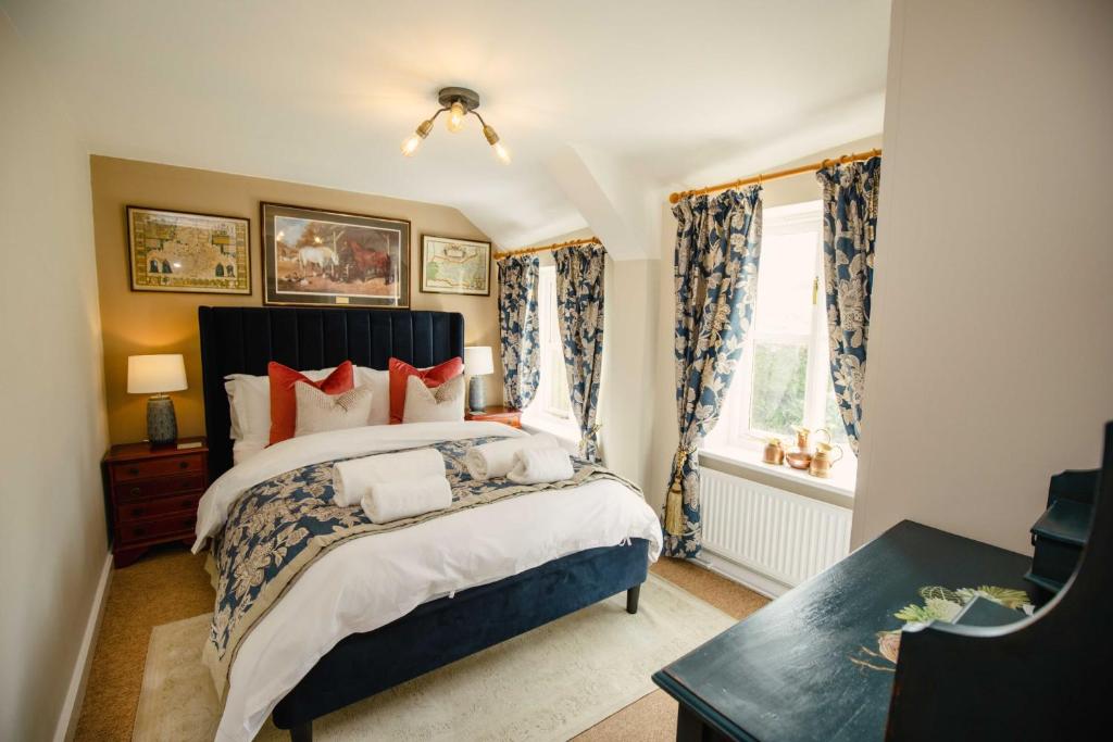 a bedroom with a large bed and a window at Thatchers Cottage - Rudge Farm Cottages in Bridport