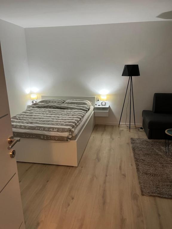 a bedroom with a bed and a couch at Apartment VBK Osijek in Osijek