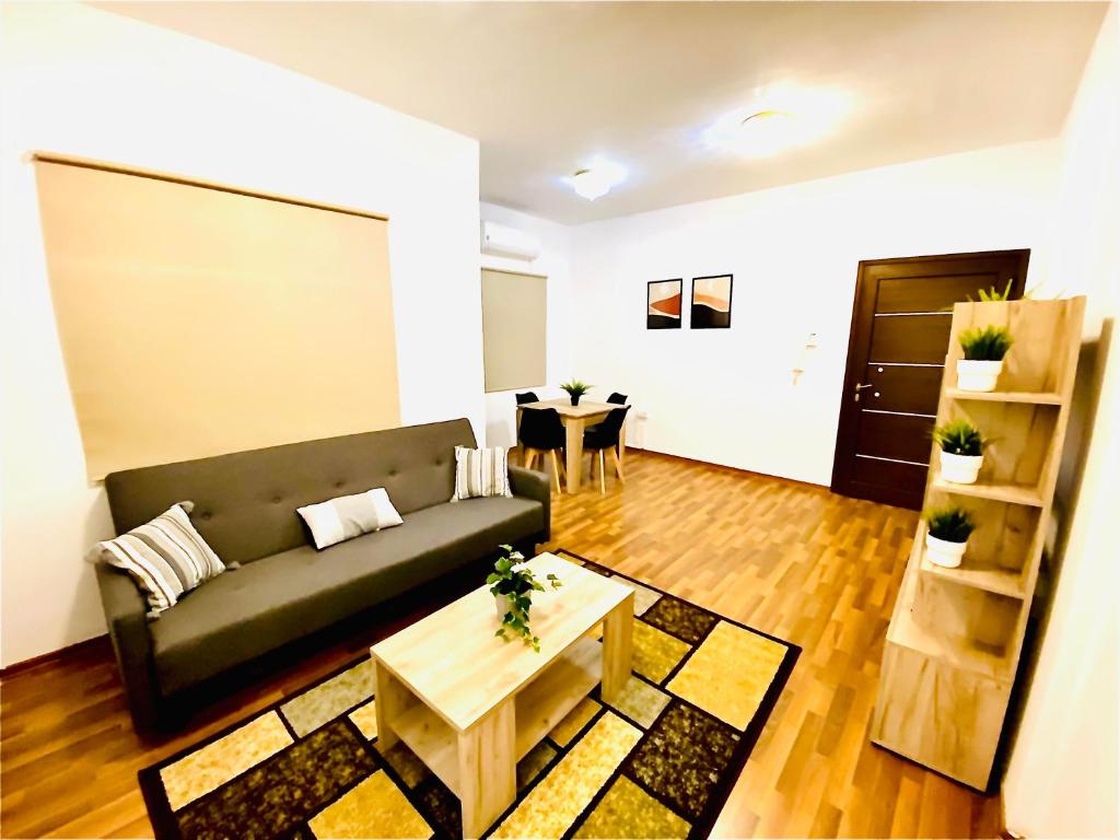 a living room with a couch and a table at CHADI APARTMENT in Larnaca