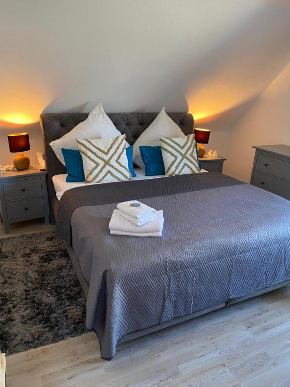 a bedroom with a large bed with blue and white pillows at B1 Ith Apartment in Coppenbrügge
