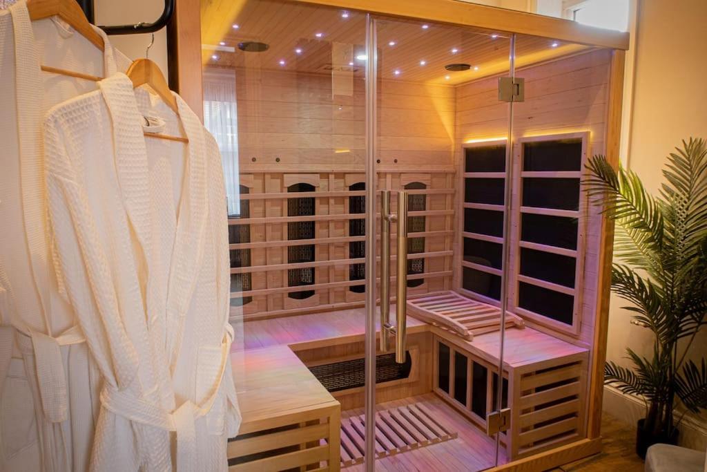 a walk in closet with a shower and a robe at Luxurious Apartment in Prestatyn in Prestatyn
